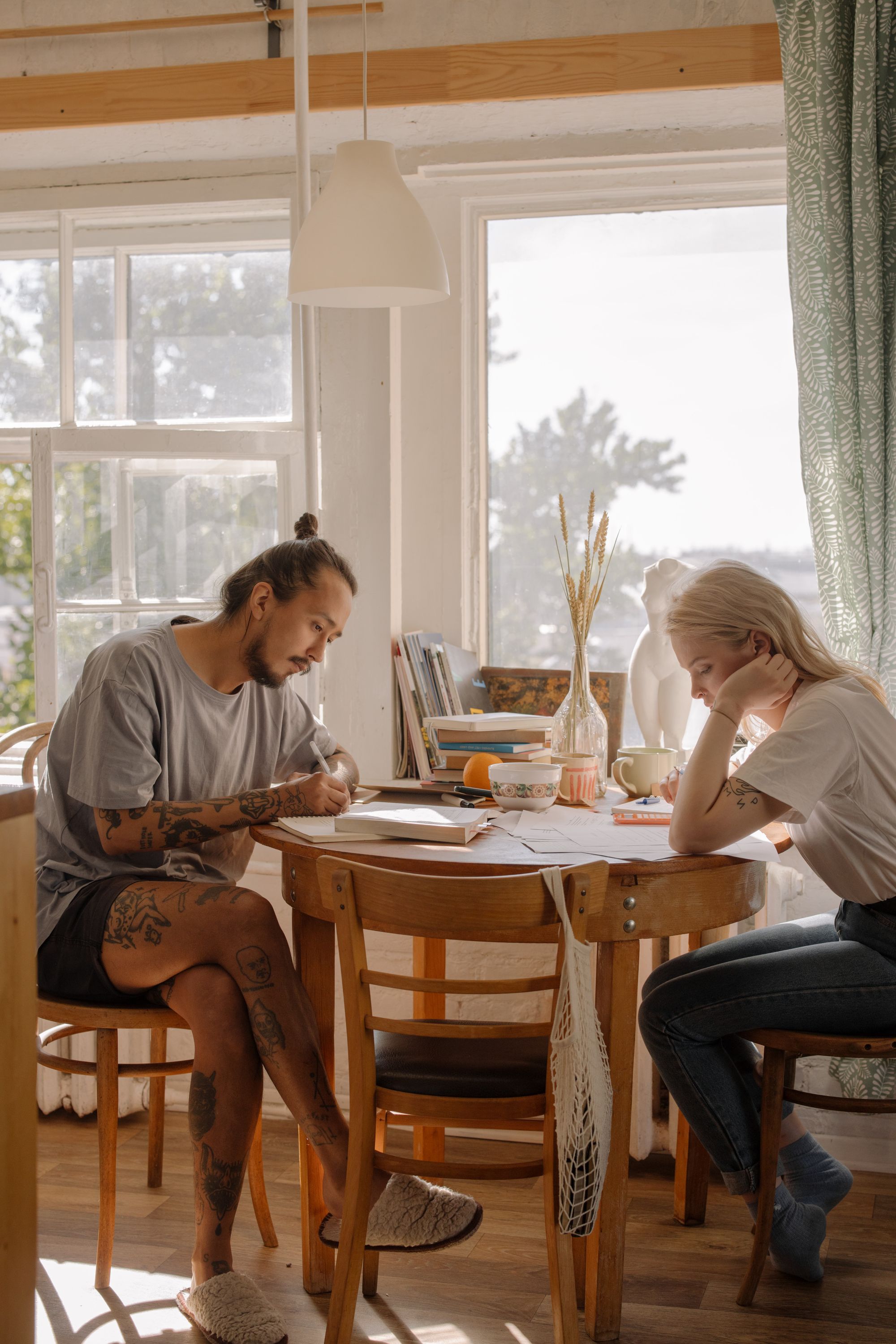 A man and a woman sitting at a table and studying