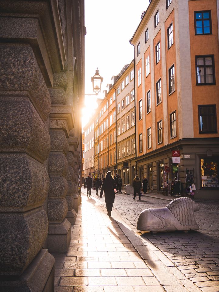 Passersbys in a narrow street in Gamla Stan, Sweden.