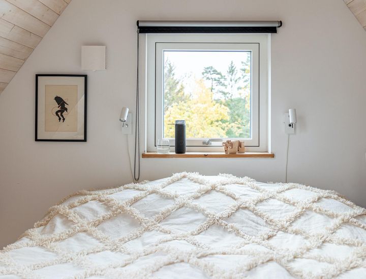 A picture of a bedroom with the with the window open