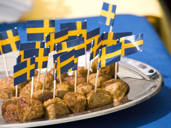 Photo of a plate of meatballs with small Swedish flags