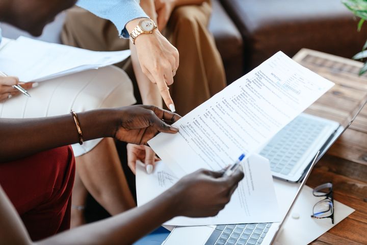 A group of individuals checking information in a few documents