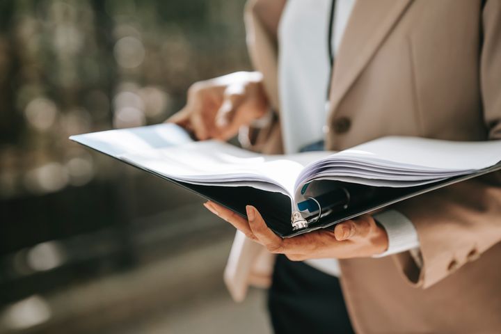 A woman checking documents in a folder