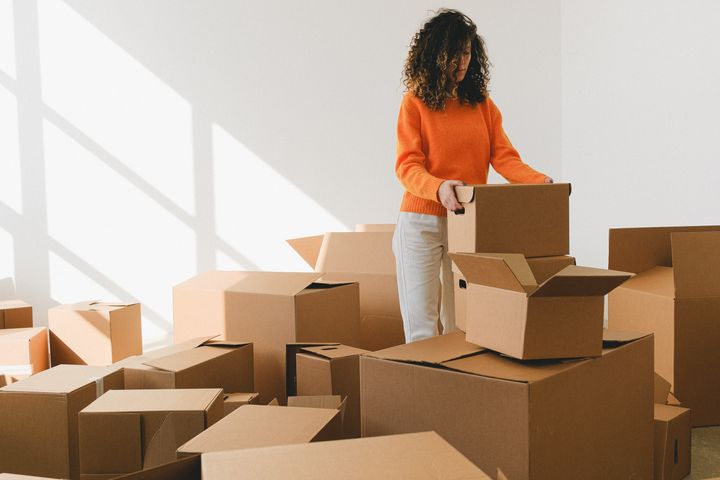 A woman packing boxes before moving into a new apartment