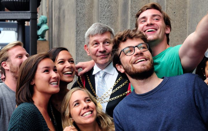 Students at the University of Copenhagen taking a selfie with an esteemed faculty member