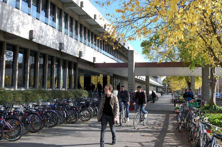 Photo of a student walking across campus at the Technical University of Denmark