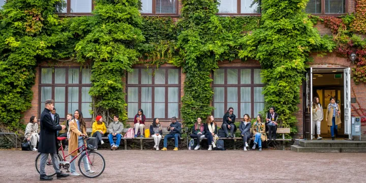 Groups of students sitting on benches at Lund University in Sweden