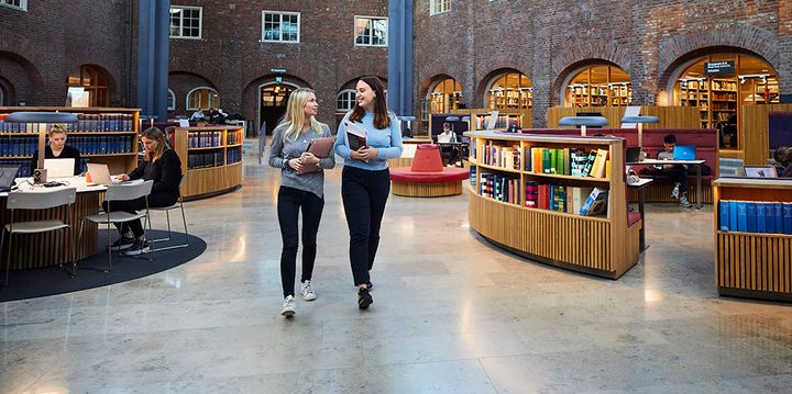 Two students walking across the KTH Library at KTH Royal Institute of Technology in Stockholm, Sweden