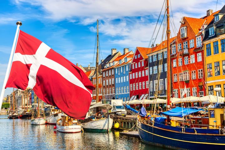 Nyhavn Canal in Copenhagen, with a Danish flag