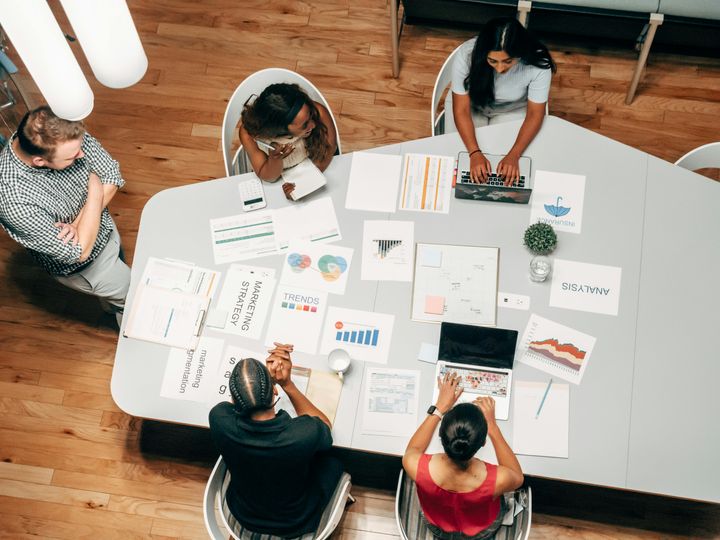 People seated around a table working on a project together